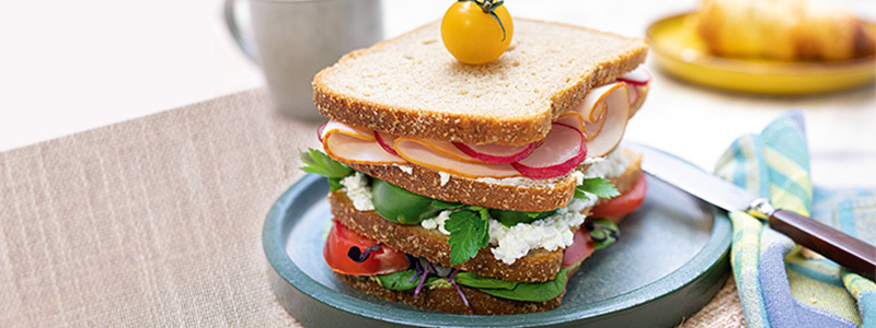 Sandwich Tower mit körnigem Frischkäse, Tomaten und Schinken